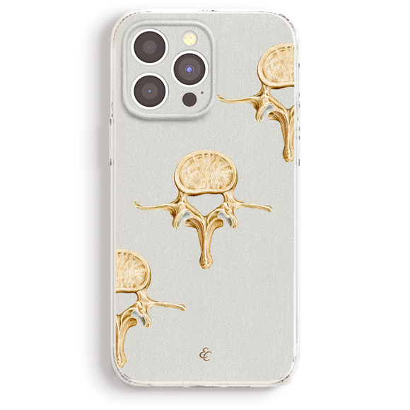 a phone case with a design of golden skull-like figures on a white background.
